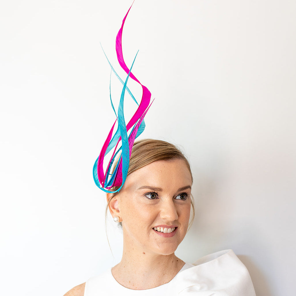 Woman wearing a colorful headpiece against a white background