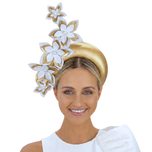 Woman wearing a gold and white floral headpiece on a white background